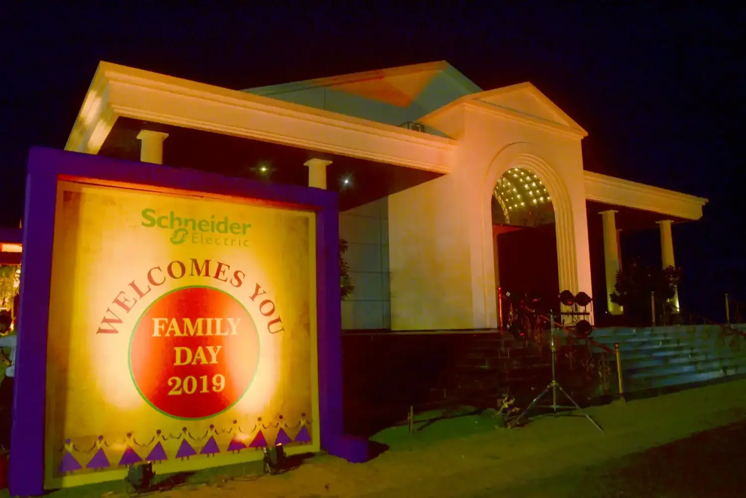 Musical performance on stage with three performers and ITT banner in background
